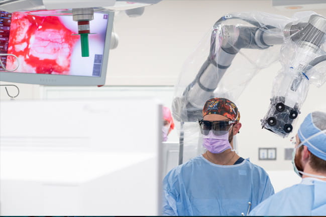 Ramin Eskandari, M.D., performs surgery using a robotic exoscope 